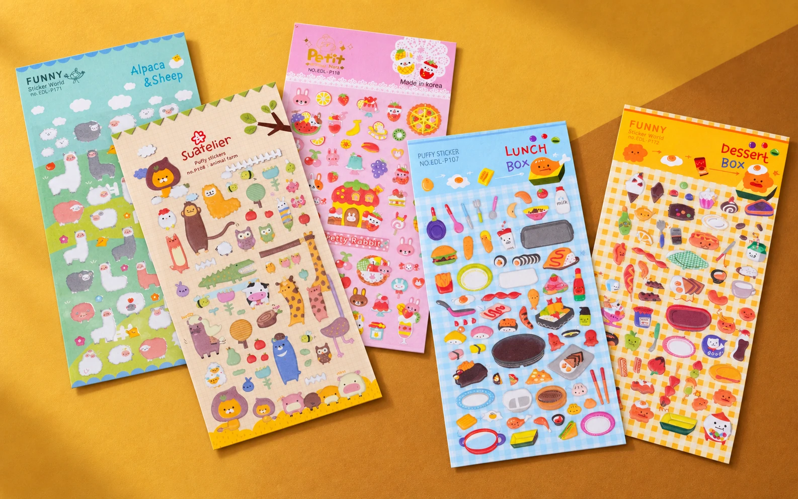 Multiple custom puffy sticker sheets with assorted animal and food designs