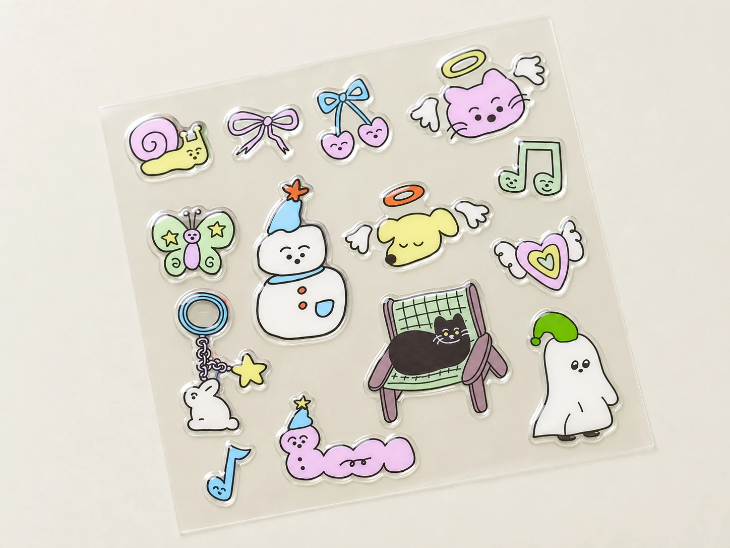 Epoxy dome stickers with raised glossy surfaces, arranged on a transparent carrier sheet.