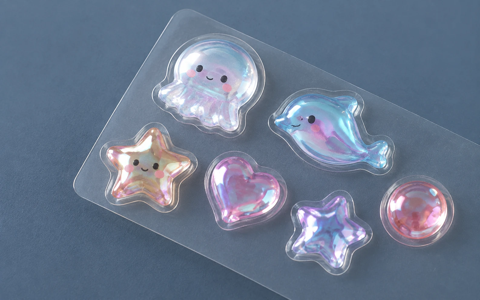 Puffy stickers with iridescent reflective finishes on clear backing