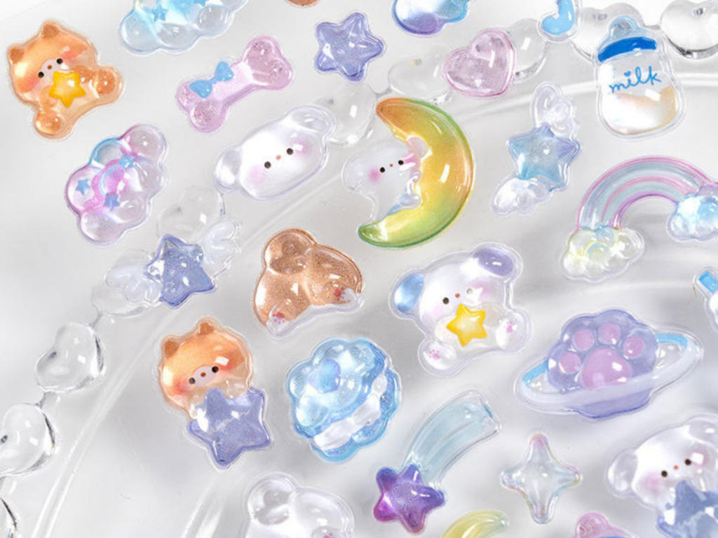 Close-up of raised moon, star and rainbow bubble stickers
