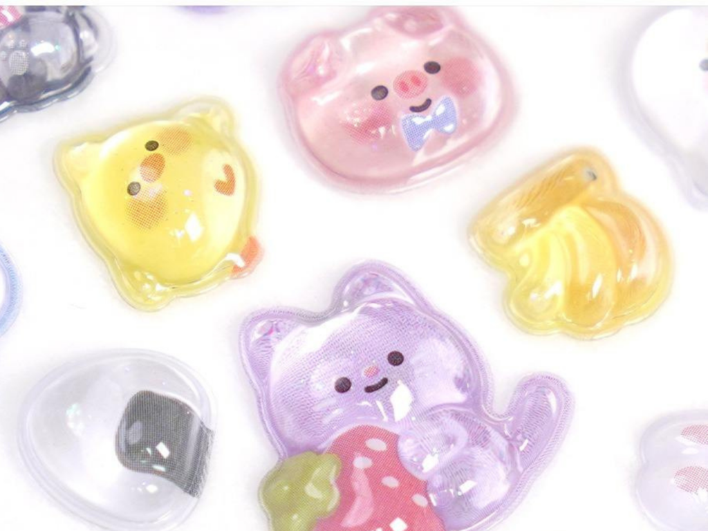 Close-up of 3D embossed bubble stickers with pastel animal and fruit designs