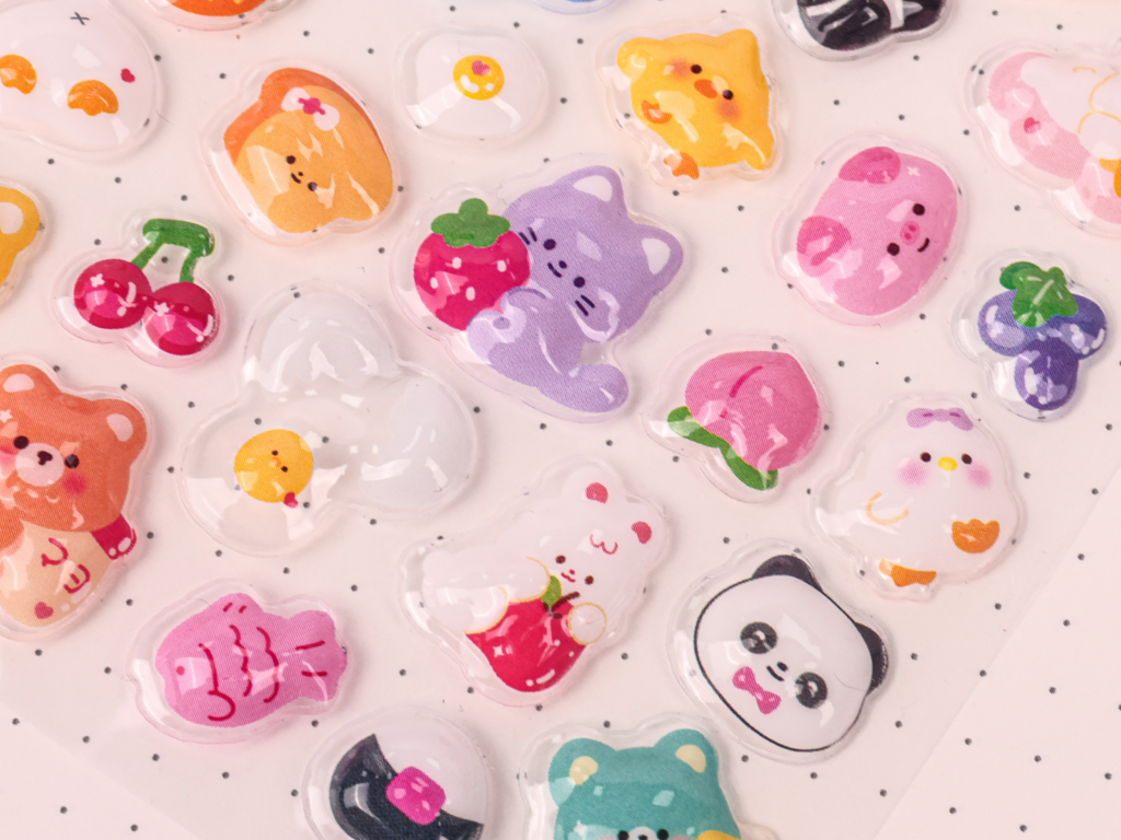 Animal and fruit bubble sticker designs on a pink sheet