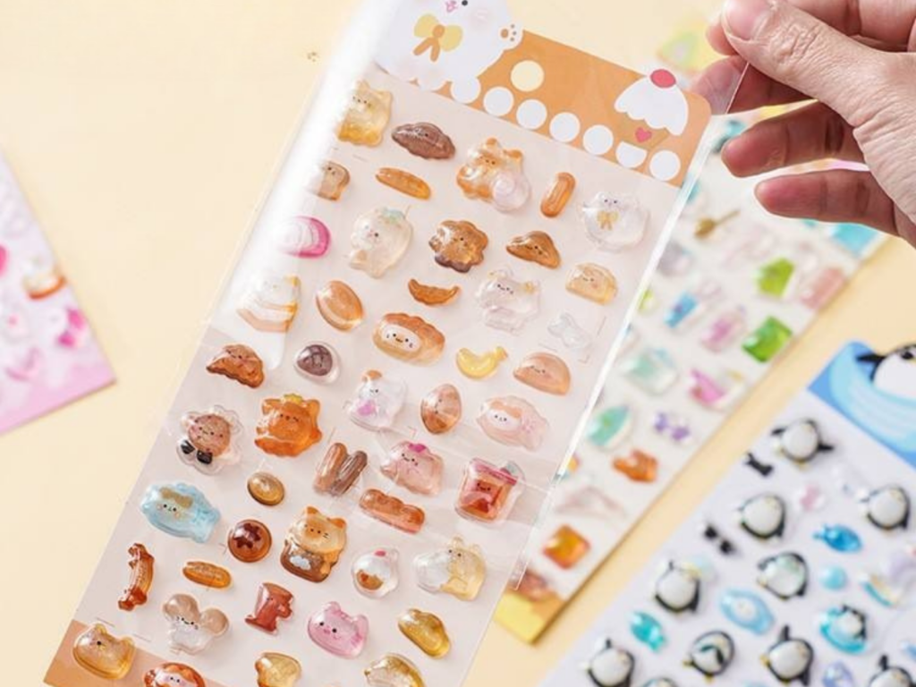 Hand holding a bakery-themed bubble sticker sheet