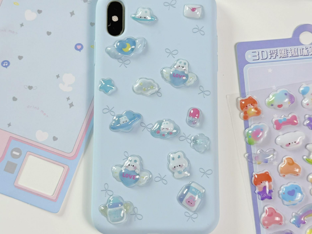 Small blue bubble stickers decorating a pale blue phone case