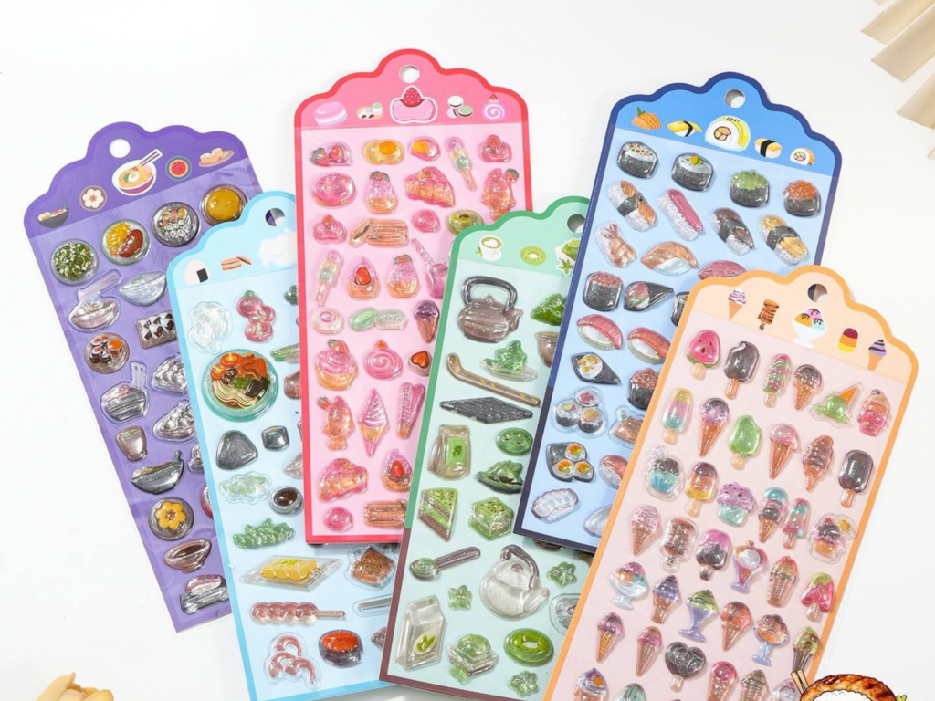 Bubble sticker sheets displayed with purple, pink, green and blue backing cards