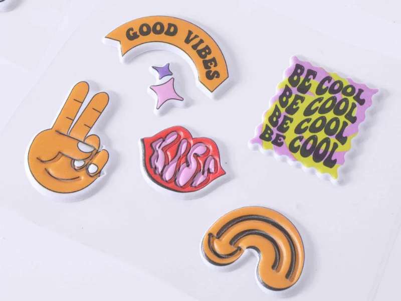 Custom raised foam puffy stickers showcasing glossy domes and holographic surface effects