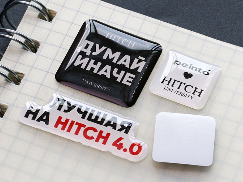 Assorted rectangular and square epoxy domed brand stickers in black and white
